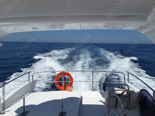 Fotografie, Obraz Wake of the luxury motor yacht sailing on the sea