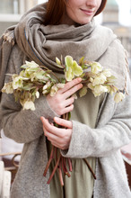 Young Woman Holding A Bouquet Of Hellebores