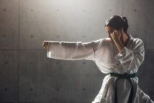 Martial Arts Concept. Young Woman In Kimono Practicing Karate