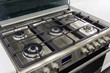 closeup of brand new, modern gas stove on countertop in contemporary modern home kitchen.