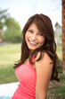 © digitalskillet1 - Young Hispanic girl smiling outside.