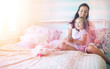 © alexkich - Young girl reads a book Young girl with a daughter are sitting o