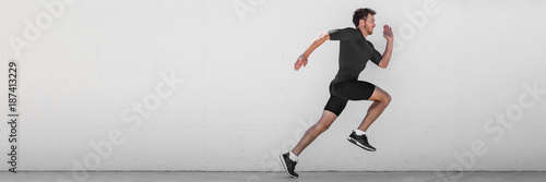 Fotomural Running man runner training doing outdoor city run sprinting along wall background
