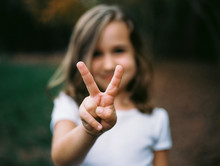 Young Girl Making The Victory Sign With Her Hand