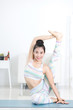 © sirikorn - Asian beautiful sports woman performs the exercises at home .