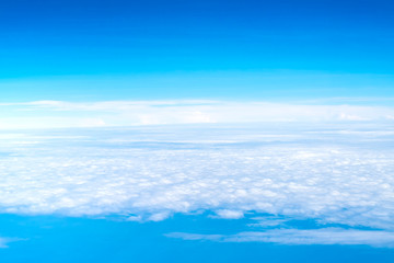Wall Mural - blue sky and cloud top view from airplane window,nature background.