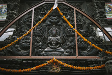 Intricate Wooden Carving Of Buddha On A Temple Door In Kathmandu, Nepal.