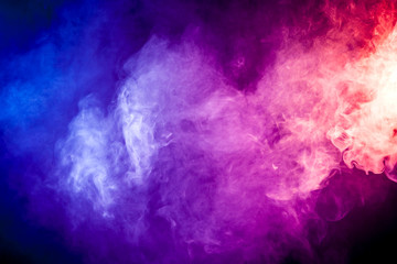 Colorful smoke clouds on dark background