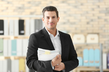 Canvas Print - Young man with documents in office