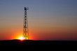 Sunset behind the communication tower. Mobile phone transmitter in the evening. 