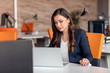 © FS-Stock - Young businesswoman using laptop at office table