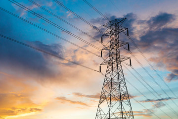 the silhouette of the evening electricity transmission pylon