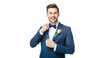 portrait of young handsome groom in suit isolated on white