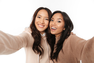 Wall Mural - Two asian happy positive ladies sisters