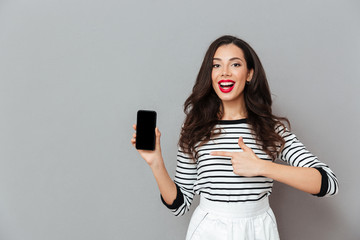 Poster - Portrait of a cheerful woman pointing finger