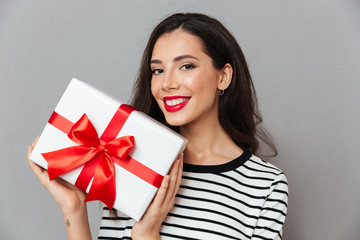 Poster - Close up portrait of a happy woman holding gift box