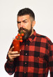 © be free - Guy holds homegrown harvest. Man with beard drinks tomato juice