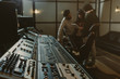 © LIGHTFIELD STUDIOS - blurred group of musicians spending time at recording studio with graphic equalizer