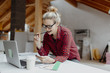 © epiximages - young, pretty, blonde woman is planning on the notebook and tablet the expansion of her loft