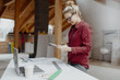 © epiximages - young, pretty, blonde woman is planning on the notebook and tablet the expansion of her loft