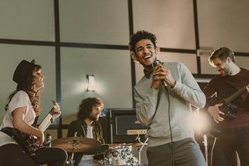 Poster - young happy musicians performing song