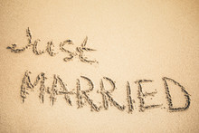 Just Married Text Written On The Sand
