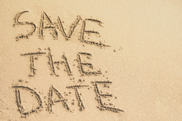 Wall Mural - Save the Date text written on the sand