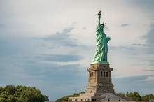 The Statue Of Liberty, An American Landmark On Liberty Island Next To Ellis Island In NYC, New York, USA With Copy Space