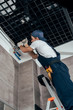 © LIGHTFIELD STUDIOS - low angle view of plumber working with pipes in bathroom