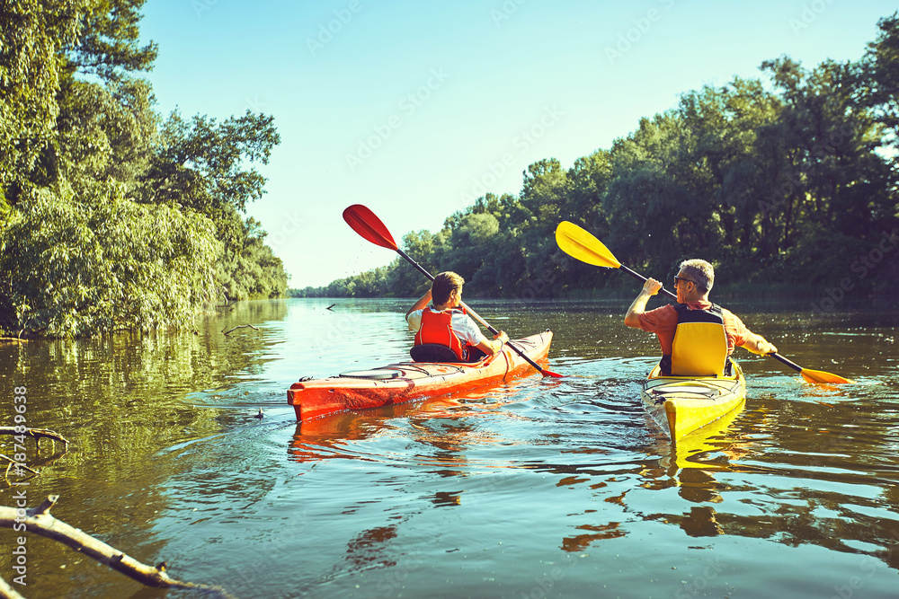A canoe trip on the river in the summer. - obrazy, fototapety, plakaty 