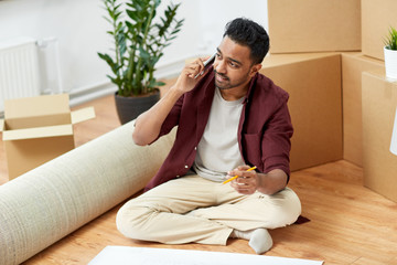 man with blueprint and boxes moving to new home