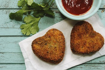 Homemade heart shaped Lamb meat cutlets / Valentines day food overhead view