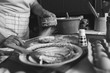© Zoran Zeremski - Senior female baker kneading dough in kitchen. Black And white.