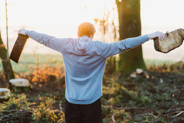 Young man doing workout in a forrest in Austria at sunrise