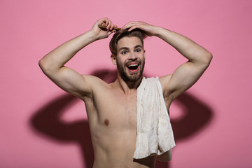 Canvas Print - Man brush hair with hairbrush on pink background