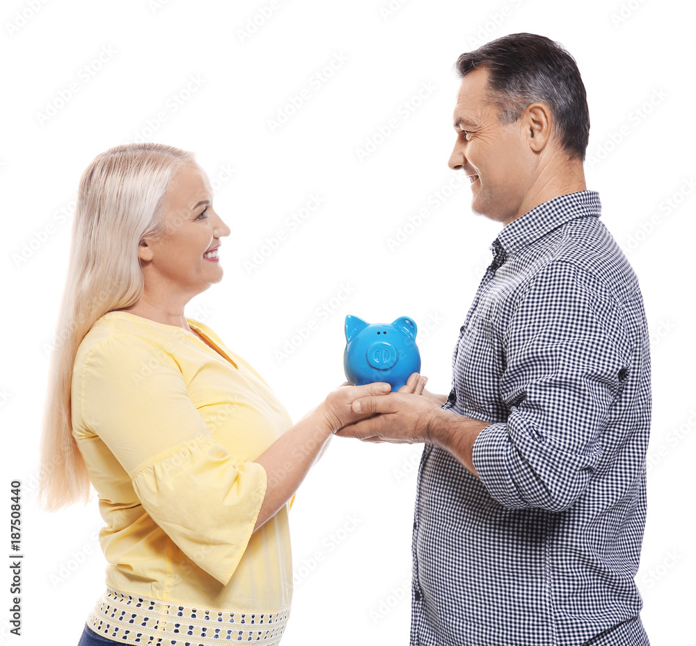 Mature couple with piggy bank on white background