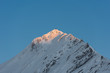 © RG&B Images/Stocksy - Snow-capped mountain peak with beautiful blue sky above