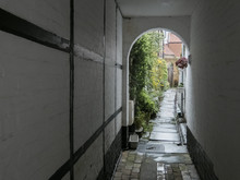 Arched Alleyway Between Buildings. Norfolk, UK.