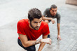 © Marko Milovanovic/Stocksy - Two friends stretching after run outdoor