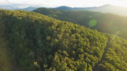 Poster - Forward flight over forested hills in Australian alps at sunset