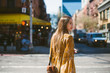 © Lauren Naefe/Stocksy - Young woman crossing street in New York City