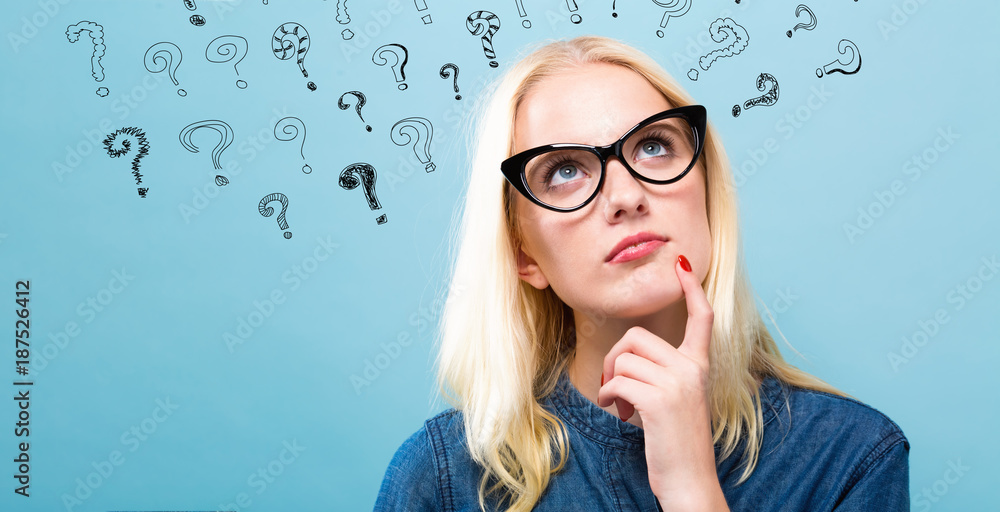 Questionable Pose Young woman in a thoughtful pose with question marks Stock Photo ...