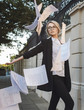 © xo4uphoto - Beautiful woman in classic suit an eyeglasses throuwing up the papers at the street