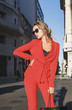 © xo4uphoto - Fashionable woman in red suit outdoors