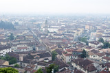 Fototapeta Do pokoju - Verona's cityscape early in the morning. Roofs and buildings of the old Italian city.