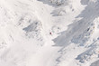 © RG&B Images/Stocksy - Male skier freeriding off piste through a snow couloir