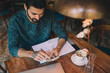 © Marija Savic/Stocksy - Young Businessman in a Cafe