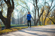 © Maksym Protsenko - Young Sports Man Running in the Park in Cold Sunny Autumn Morning. Healthy Lifestyle and Sport Concept.