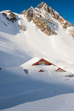 Chalet Covered By Powdery Snow In Mountains
