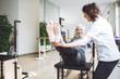 © Lumina/Stocksy - Woman Doing Legs Exercise With Therapist